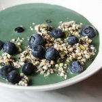 seed muesli with blue-green spirulina milk and blueberries